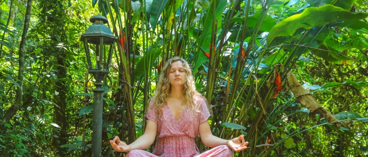 woman in pink dress sitting on wooden pathway