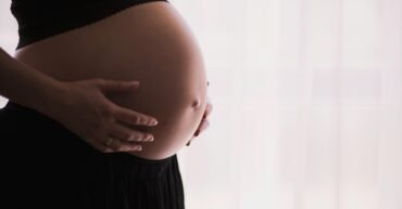 woman holding stomach